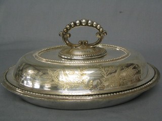 An oval engraved silver plated entree dish with bead work border