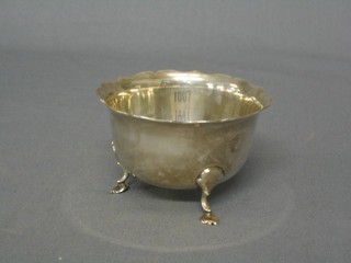 A circular silver sugar bowl with wavy cut border, raised on paw feet, London 1929 by the Goldsmiths & Silversmiths Co. 3 ozs