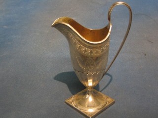 A Victorian Georgian style engraved silver cream jug, raised on a square base, London 1892, makers mark JHR, 5 ozs