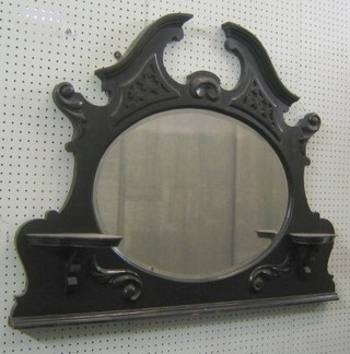 An Edwardian oval over mantel mirror contained in an ebonised frame 38"