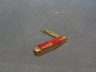 A 1930's multi-bladed jack knife, 3" with red coloured grip