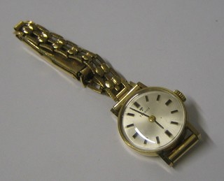 A lady's Tissot wristwatch contained in a gold case with integral bracelet