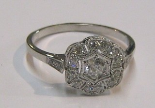 A lady's gold dress ring set a large diamond to the centre, 4 diamonds to the shoulders and numerous other diamonds (approx 0.54ct)