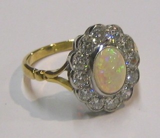 A lady's 18ct gold dress ring set an oval opal surrounded by 12 diamonds (approx 1ct)
