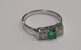 A lady's 18ct white gold dress ring set an emerald and 2 diamonds (approx 0.40ct)