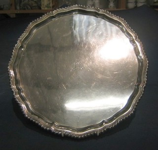 A silver salver with bracketed border monogrammed M raised on 4 hoof feet Sheffield 1951, 14" 34 ozs