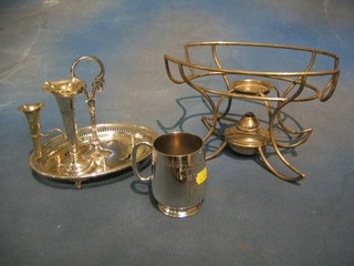 A silver plated christening tankard, an egg cruet stand, a part section of epergne and a warming stand