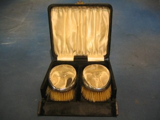 A pair of silver backed military hair brushes Birmingham 1931, cased