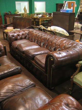 A 20th Century wooden framed 4 seat Chesterfield upholstered in brown buttoned back hide, 96"