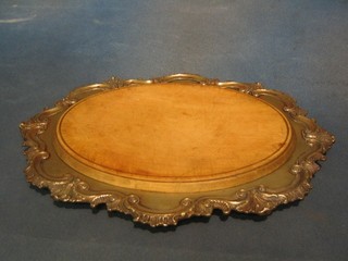 An oval cheese board contained in a silver plated frame 14"