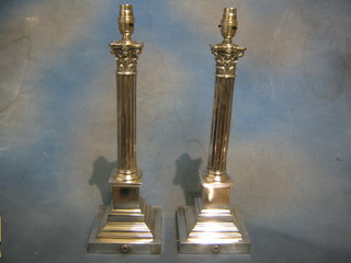 A pair of reeded silver plated column table lamps with Corinthian capitals 17"