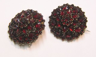 2 gilt metal brooches set red stones