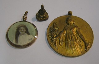 A French gilt metal religious medal, a gilt metal double locket and a seal