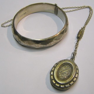 A silver bangle and a silver locket