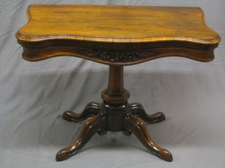 A Victorian shaped rosewood card table, raised on octagonal chamfered column and tripod base 36"