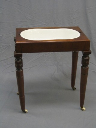 A Victorian mahogany bidet complete with china liner raised on turned supports 24" (no lid)