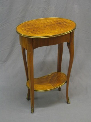 A 19th/20th Century oval French Kingwood 2 tier occasional table with gilt metal rim, fitted a drawer, raised on cabriole supports with undertier, 19"
