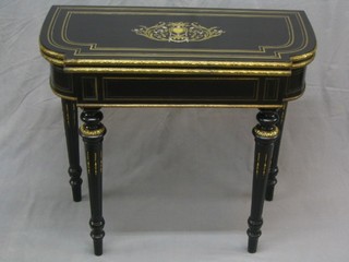 A 19th Century French ebonised and gilt inlaid card table, raised on turned and fluted supports with gilt metal mounts throughout, 34"