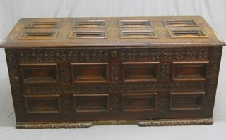 An 18th/19th Century Continental carved oak coffer of panelled construction with hinged lid 60"