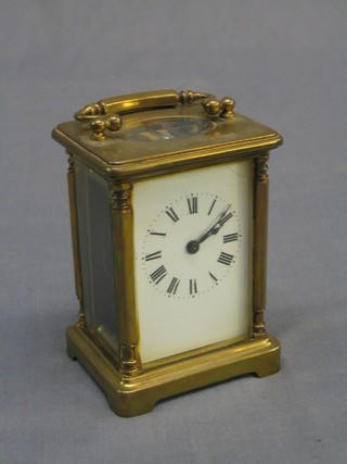 A 19th Century French 8 day carriage clock with enamelled dial and Roman numerals contained in a gilt metal case (crack to top right hand corner of dial)