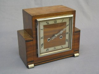 A 1930's Art Deco 8 day striking mantel clock with square silvered dial and Roman numerals contained in a walnut case