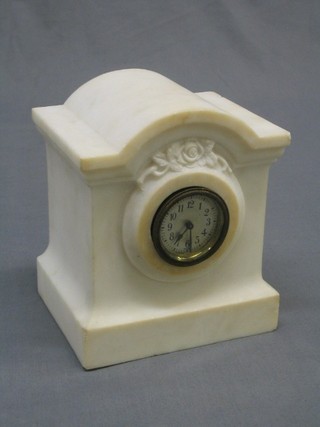 A French timepiece with 2" silvered circular dial and Arabic numerals contained in a solid white marble arch shaped case