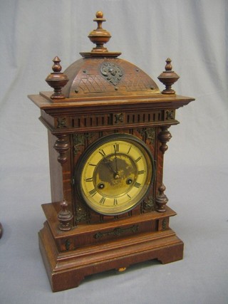 An Edwardian striking bracket clock contained in a carved oak case