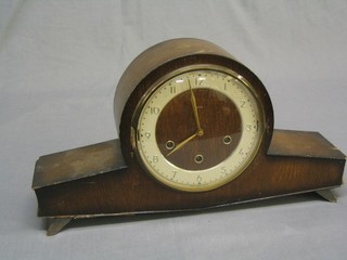 An Art Deco 8 day chiming mantel clock contained in an oak stylised Admiral's hat shaped case
