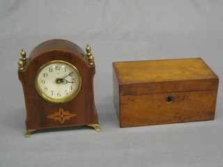 A battery operated mantel clock contained in an inlaid mahogany case