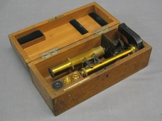 A 19th Century brass single pillar microscope by E Leitz contained in a mahogany case