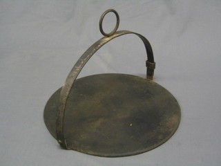 A circular cast iron drop trivet