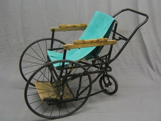 A 1930's metal framed 3 wheeled bath chair with solid tyres