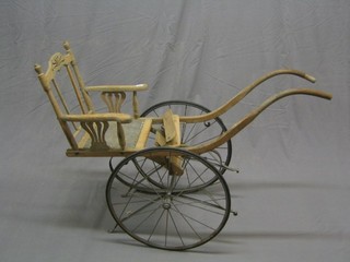 A 19th Century iron and wooden framed dog or goat cart with solid wheels