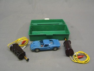 A Cox slot car together with 2 hand controls