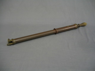 A copper garden syringe