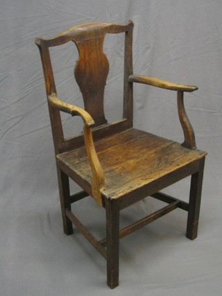 An 18th/19th Century Queen Anne style Country oak solid seat carver chair with splat back, raised on square supports
