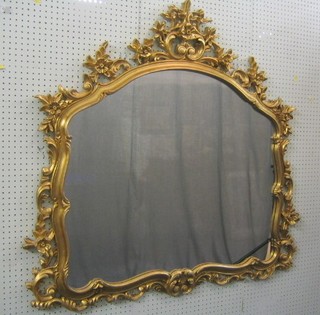 A 20th Century Victorian style arched plate over mantel mirror contained in a decorative gilt frame 44"