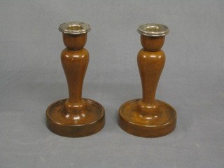 A pair of 1930's turned mahogany candle sticks with detachable silver plated sconces 7"