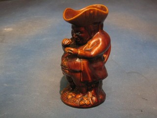 A 19th Century Staffordshire treacle glazed Toby jug in the form of a standing Toby Philpot taking snuff 9"