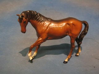A Beswick figure of a standing bay horse standing 3 feet with left hoof crooked, 7"