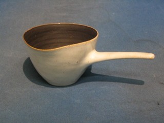 Dame Lucie Rie, an Art Pottery side handled pouring vessel with white glazed exterior and brown glazed interior, 5"
