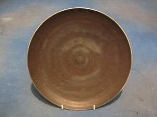 Dame Lucie Rie,  a circular Art Pottery charger with brown glazed interior and white glazed exterior, 10"