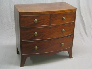 A Georgian mahogany bow front chest of 2 short and 2 long drawers with brass circular handles and inlaid banding to the apron, raised on splayed bracket feet 35"