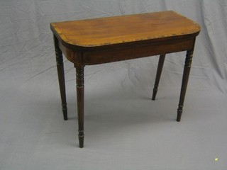 A Georgian mahogany demi-lune card table, inlaid satinwood stringing and coromandel crossbanding, raised on turned supports 36"