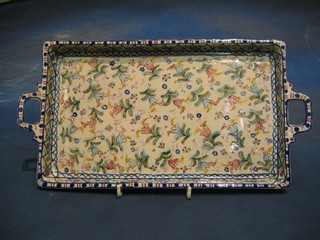 A 19th Century rectangular faience twin handled tray with floral decoration 12"
