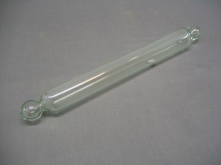 A novelty clear glass rolling pin, the interior with a 1913 silver coin