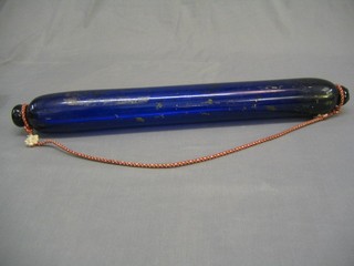 A large blue glass rolling pin decorated sailing ships (some rubbing) 29"
