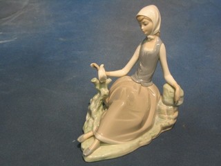 A Lladro figure of a seated lady, base marked Daisa, 7"