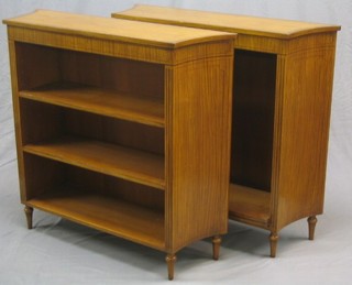 A pair of 20th Century Sheraton style crossbanded satinwood bookcases, the interiors fitted adjustable shelves, raised on turned feet, 42"