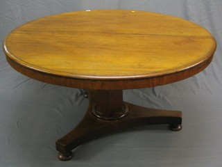 A circular Victorian snap top breakfast table, raised on a chamfered column and triform base, 54"